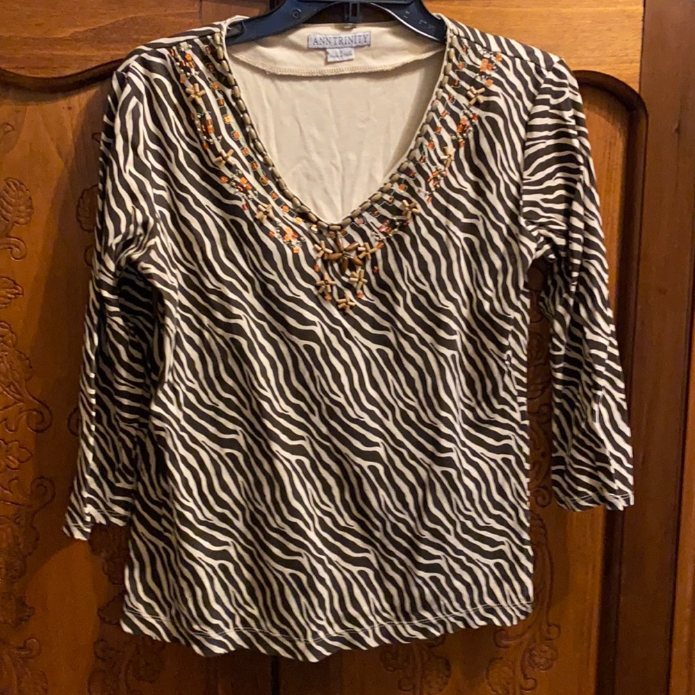 Animal print top with beaded design neckline